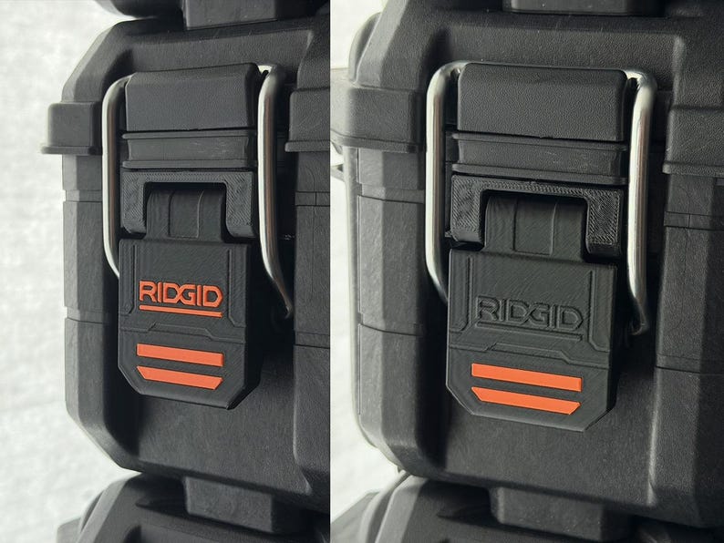 Puede incluir: Primer plano de un cierre de caja de herramientas negro con el nombre de la marca "RIDGID" en naranja. El cierre tiene dos rayas horizontales naranjas y un asa de metal plateado. La caja es negra.