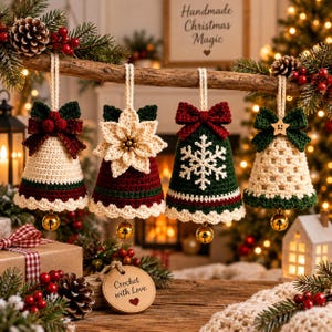 May include: Four crocheted bell ornaments hanging from a wooden branch. Each bell features unique details: a red bow with berries, a cream poinsettia, a white snowflake on green, and a cream lattice pattern with a green bow and wooden star.