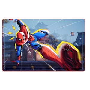 May include: A red and blue Spider-Man graphic on a rectangular arcade-style controller. The controller has a red border and a yellow outline around the character. The background shows a cityscape with a blue sky.