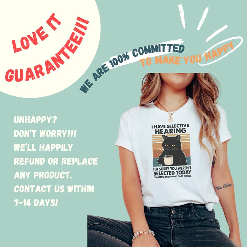 May include: White t-shirt with a graphic of a black cat holding a mug, text reads "I have selective hearing" and "I'm sorry you weren't selected today". The shirt also has text that says "Tomorrow isn't looking good either".