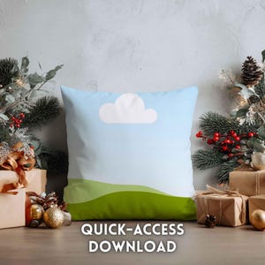 May include: A square cushion with a sky and cloud design. The cushion features a light blue gradient background with a white cloud and green hills. The text "QUICK-ACCESS DOWNLOAD" is at the bottom. The cushion is surrounded by Christmas decorations.