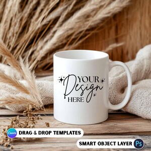 May include: A white ceramic mug with a curved handle, featuring the text "YOUR Design HERE" in black script. The mug is set against a backdrop of dried plants and a neutral-toned fabric, with the words "DRAG & DROP TEMPLATES" and "SMART OBJECT LAYER" at the bottom.