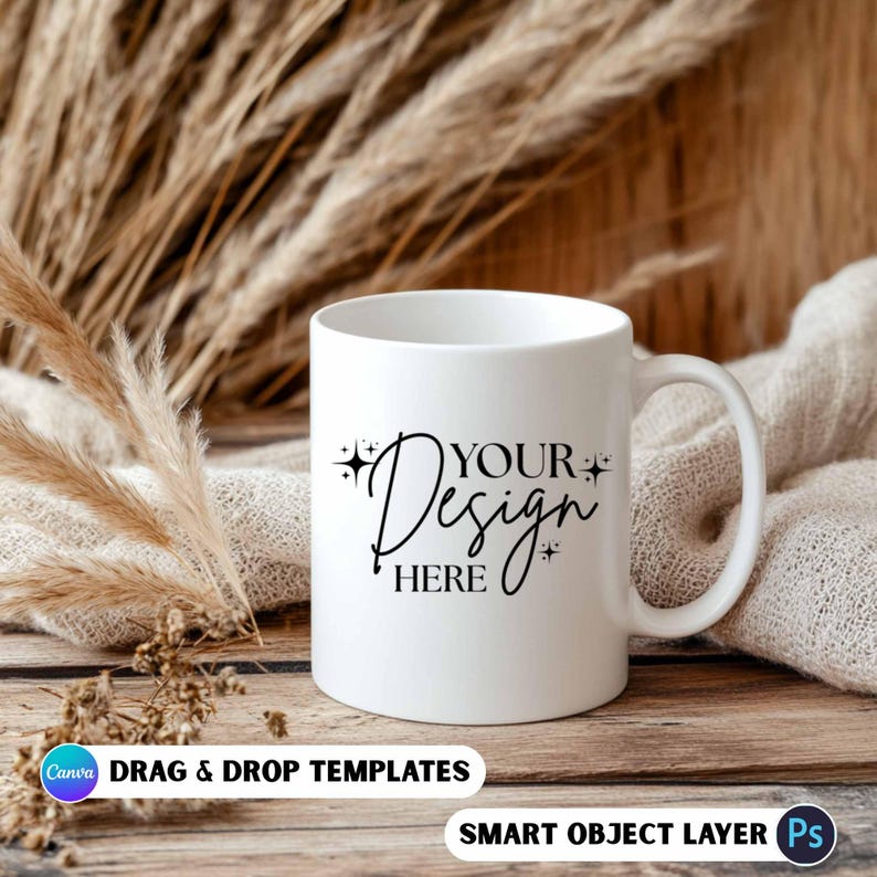May include: A white ceramic mug with a curved handle, featuring the text "YOUR Design HERE" in black script. The mug is set against a backdrop of dried plants and a neutral-toned fabric, with the words "DRAG & DROP TEMPLATES" and "SMART OBJECT LAYER" at the bottom.