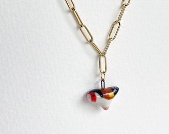 Goldfinch. Miniature bird. Porcelain charm. Miniature birdie. Cute, delicate bird charm