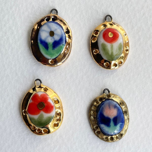 Flower. Daisy. Poppy. Tulip. Hand painted flower in a golden frame porcelain charm. Miniature painting, pedant of a flower