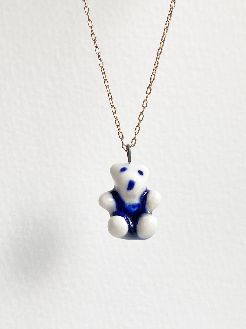 Teddy bear. Miniature teddy. Porcelain charm. Cute, delicate teddy bear charm Blue trousers