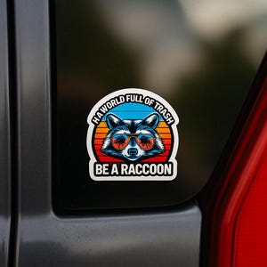 In a World Full of Trash Be a Raccoon Sticker – Funny Vinyl Raccoon Sticker for Water Bottles, Laptops, Cars, Coolers, or Journals