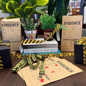 May include: A collection of crime scene-themed items, including black gift boxes with yellow caution tape, evidence bags, and a lanyard. The scene is decorated with plants and books, creating a unique display.