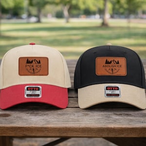 May include: Two baseball caps with leather patches and the text "F*CK ICE" and "ABOLISH ICE". One cap is beige and red, the other is black and beige. Both have the "OTTO" brand tag.