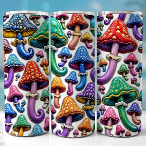 May include: A cylindrical tumbler featuring a vibrant, repeating pattern of mushrooms in various colours including red, blue, green, orange, and purple. Each mushroom has a distinct cap with spots and a stem, set against a clean white background.