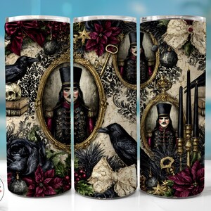 May include: A cylindrical tumbler featuring a dark, ornate pattern with portraits of figures in military-style uniforms and top hats, black ravens, skulls, red poinsettias, black candles, gold frames, and cream-coloured lace bows on a textured background.