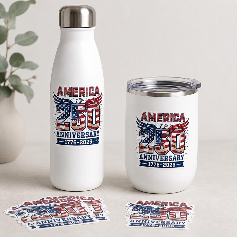 a white water bottle and a white tumbler with the text "AMERICA 250" printed on them, along with an American flag design. There are also several stickers with the text "AMERICA 250" printed on them.