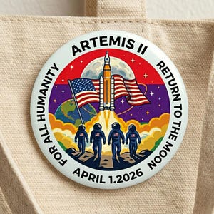 May include: A white ceramic mug with a black handle and the text "But First, Coffee" in a black, handwritten-style font. The mug is on a white surface.