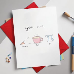 May include: A white greeting card with the words "you are" above a graphic of an acute angle, a pink teacup, and the pi symbol. The word "Acute" is below the angle, "Tea" is below the teacup, and "Pi" is below the symbol.