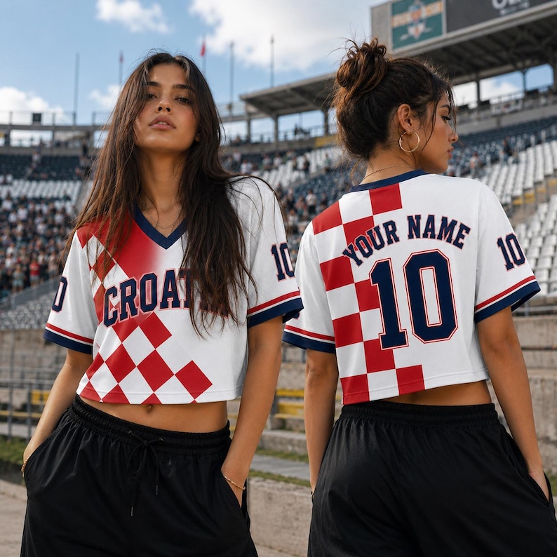 Two women wearing Croatian soccer jerseys with the number 10, posing in front of a stadium.