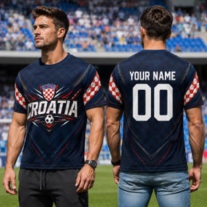 A man wearing a Croatia soccer jersey with the word "Croatia" printed on it, standing on a soccer field.