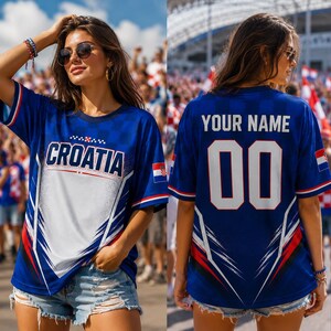 A woman wearing a blue Croatia jersey with the number 00, standing in front of a crowd at a sporting event.