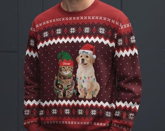 May include: A burgundy Christmas sweater featuring a cat and a dog wearing festive hats and string lights. The sweater has a snowflake and zig-zag pattern in white. The cat's hat says "Oscar" and the dog's hat says "Max".