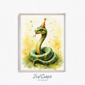 May include: Watercolor illustration of a green and yellow snake wearing a party hat. The snake is coiled in grass, with confetti and a yellow background. The artwork is framed in a light wood frame.