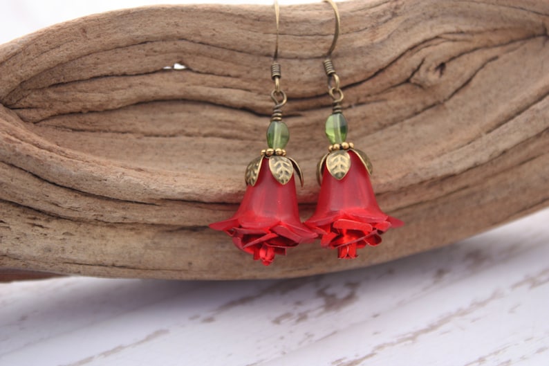 May include: Red rose flower earrings with green glass beads and gold accents.
