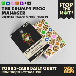 May include: A deck of cards with the text "THE GRUMPY FROG MANAGER" and "YOUR 2-CARD DAILY QUEST". One card shows a green frog character. The other cards have a repeating pattern of the words "DAILY BUF".