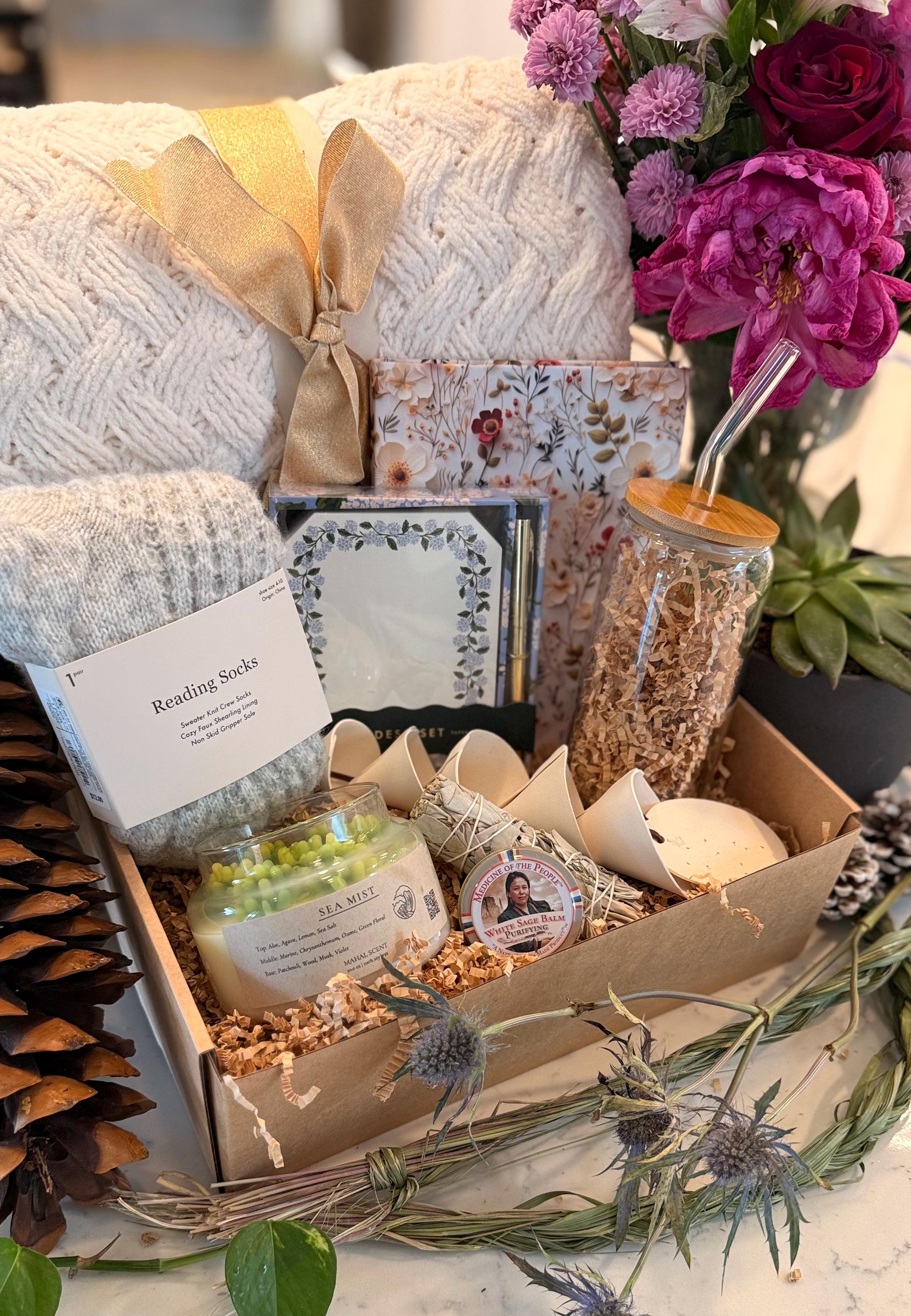 Care Package with clay wind chime, blanket, glass coffee cup, prayer journal, hand-poured candle, socks, notepad, sage bundle and salve