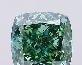 May include: A cushion-cut gemstone with a vibrant green hue. The facets of the stone reflect light, creating a sparkling effect. The gemstone's shape is square with rounded corners, and it appears to be set against a white background.