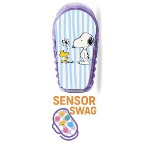 May include: A purple sensor device featuring Snoopy and Woodstock characters on a blue and white striped background. The text "SENSOR SWAG" is displayed below, along with a graphic of smiling faces.
