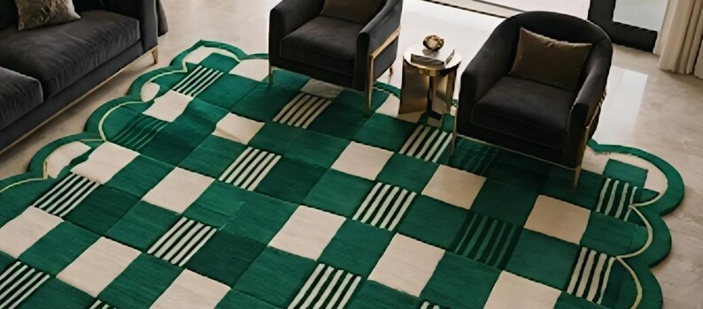 May include: A green and white patterned area rug with a scalloped edge. The rug features a checkerboard design with alternating squares of solid green, white, and green with black and white stripes. The rug is placed in a living room setting.