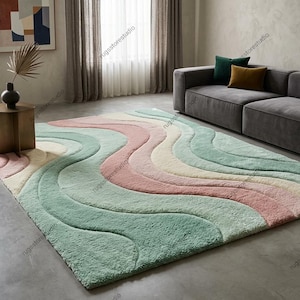 Wavy pattern retro 70s style area rug with 3D carved high-low pile texture featuring pastel pink, sage green, and cream colors on a living room floor.