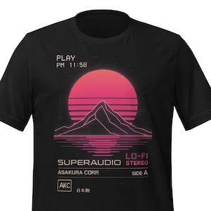Op de afbeelding: Zwart t-shirt met een retro zonsondergangontwerp, een berg silhouet en waterreflectie. Tekst bevat "PLAY PM 11:58", "SUPERAUDIO STEREO", "LO-FI", "ASAKURA CORP.", "SIDE A" en Japanse tekst. Een grafisch t-shirt.