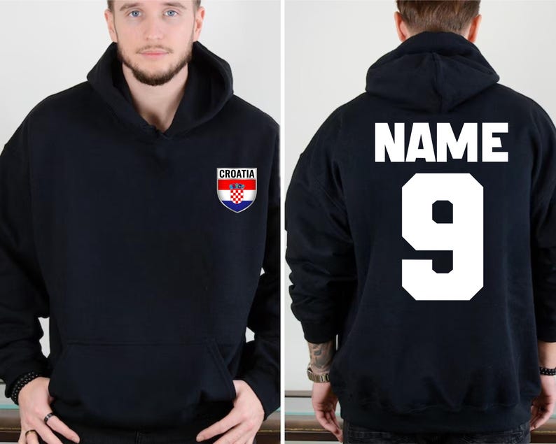 May include: Black hooded sweatshirt with the Croatian coat of arms on the front. The back of the sweatshirt displays the word "NAME" above the number "9" in white block letters. The sweatshirt has a front pocket.