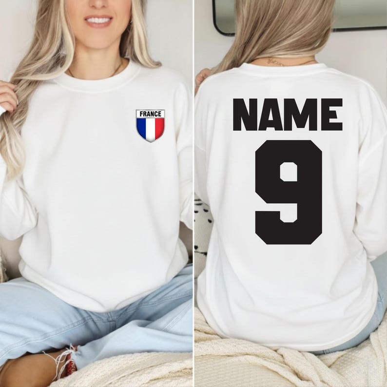 May include: White sweatshirt with a small France emblem on the front and the word "NAME" and the number "9" on the back in black. The France emblem is a shield with blue, white, and red vertical stripes.