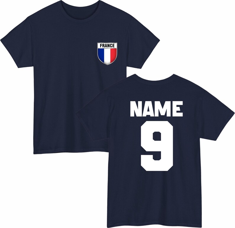 May include: Navy blue t-shirt with a French flag emblem on the chest. The back of the shirt displays the word "NAME" above the number "9" in white block letters. A classic design for sports fans.