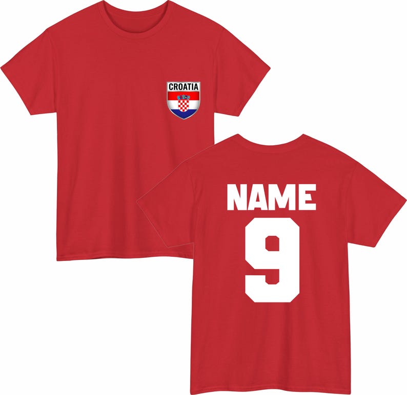 May include: A red t-shirt featuring a Croatian flag emblem on the front and the number 9 with the word "NAME" on the back. The emblem is a shield shape with the Croatian flag design. The shirt is a short-sleeved crew neck.