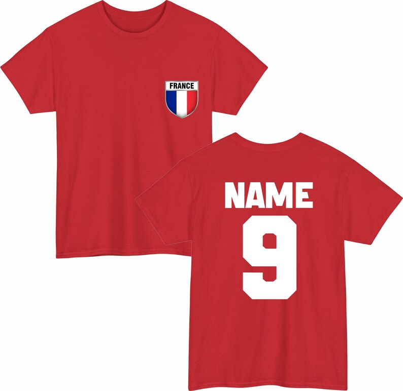 May include: Red t-shirt with a French flag emblem on the chest. The back of the shirt displays the word "NAME" above the number "9" in white block letters. A sporty design.