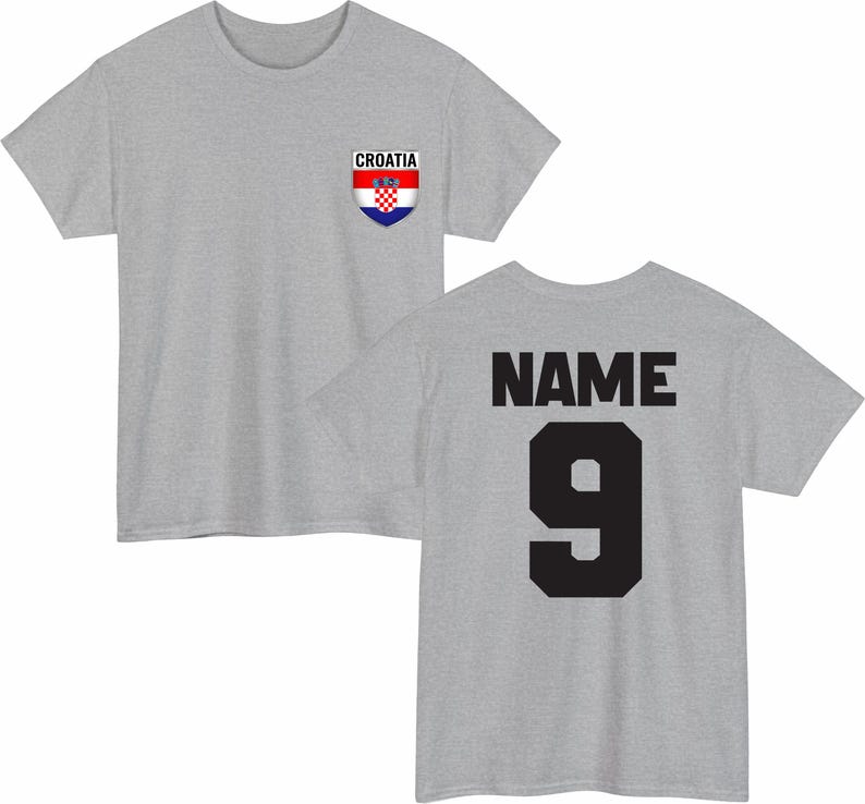 May include: A heather gray t-shirt with the Croatian flag emblem on the front and the word "CROATIA" above it. The back of the shirt displays the word "NAME" above the number "9" in black.