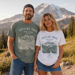 Couple wearing Moss and White Skyline Trail Mount Rainier National Park hiking shirts with Mount Rainier in the background.