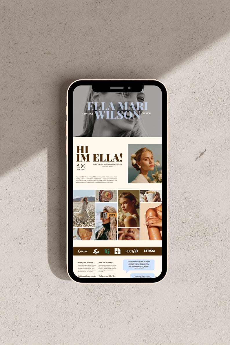 May include: A smartphone displaying a digital portfolio website for a content creator named Ella Mari Wilson. The screen features a black and white header photo, a profile section with text, a grid of lifestyle images, and brand logos including Canva, HubSpot, and Strava.