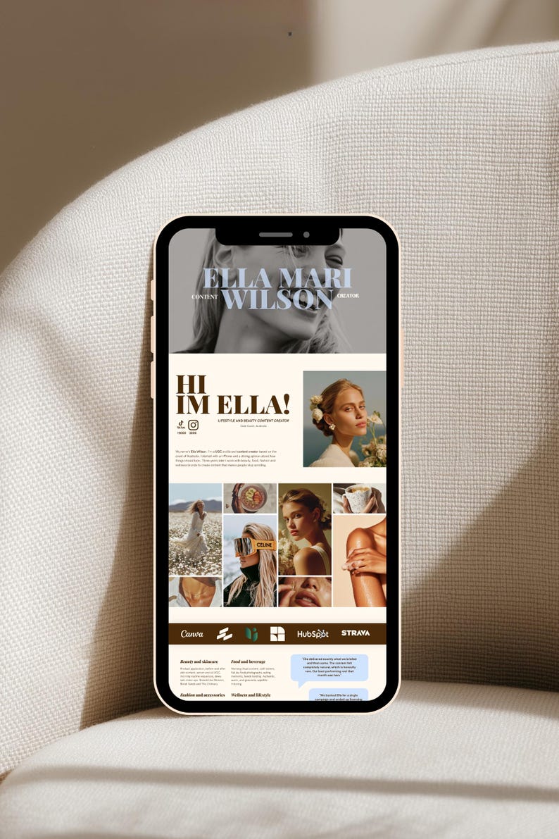 May include: A smartphone displaying a digital portfolio website for Ella Mari Wilson, a content creator. The screen features a black and white header photo, the text "HI IM ELLA!", a grid of lifestyle photographs, and brand logos including Canva and HubSpot.