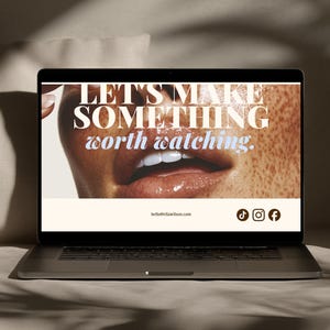 May include: A laptop screen displaying a webpage with a close-up image of a person's mouth and freckled skin. The text reads LET'S MAKE SOMETHING worth watching. Below is the email address hello@ellawilson.com and icons for TikTok, Instagram, and Facebook.