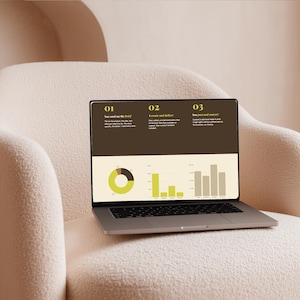 May include: A silver laptop displaying a presentation with charts and text, set against a brown background. The laptop is open on a cream-colored, textured armchair. The screen shows a pie chart and bar graphs, with the numbers 01, 02, and 03 at the top.