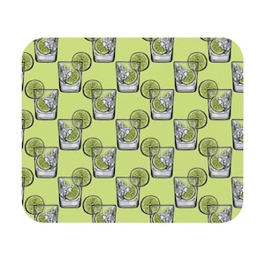 May include: A rectangular mousepad featuring a repeating pattern of cocktails. Each glass is filled with ice cubes and a lime wedge. The background is a light green color.