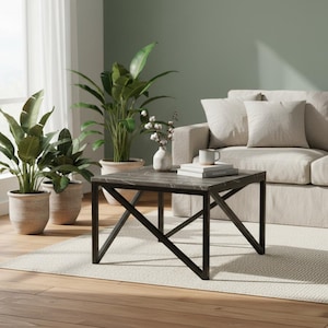 Peut inclure: Une table basse carrée avec un plateau aspect marbre gris foncé et des pieds en métal noir. La table est dans un salon avec un canapé beige, des plantes et un tapis. La table mesure environ 76 cm de large.