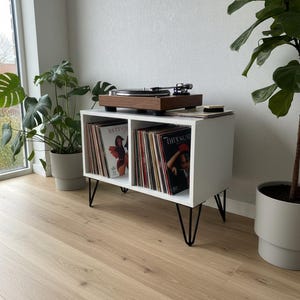 Modern record player stand with spacious vinyl storage below and a sturdy top surface for a turntable. Minimalist design made from solid wood, ideal for living room or music corner organization.