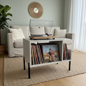 Modern record player stand with spacious vinyl storage below and a sturdy top surface for a turntable. Minimalist design made from solid wood, ideal for living room or music corner organization.