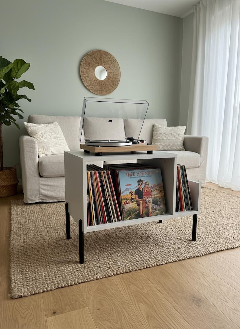 Modern record player stand with spacious vinyl storage below and a sturdy top surface for a turntable. Minimalist design made from solid wood, ideal for living room or music corner organization.