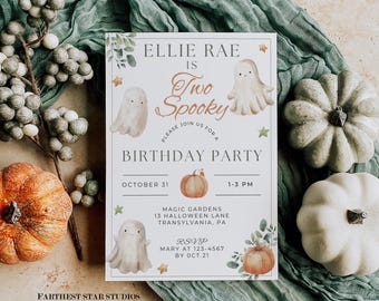 May include: A Halloween-themed birthday party invitation with the text "Ellie Rae is Two Spooky." The invitation features illustrations of ghosts and pumpkins. The invitation is surrounded by pumpkins, berries, and a green cloth.