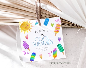 May include: A white card with a watercolor illustration of a smiling sun, popsicles, and hearts. The text on the card reads "Have a Cool Summer! Your friend, Ronan."  The card is attached to a brown string.