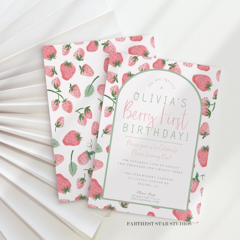 May include: A pink and green first birthday invitation with a strawberry pattern. The invitation says "Olivia's Berry First Birthday!" and includes details for the party, including the date, time, location, and RSVP information.